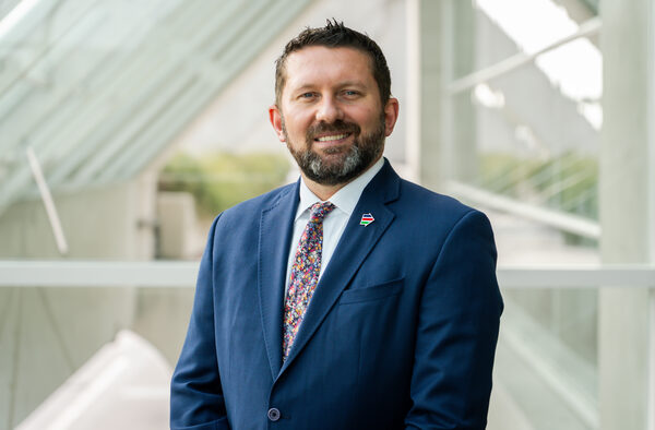 Shawn VanDiver headshot, navy suit, San Diego Convention Center