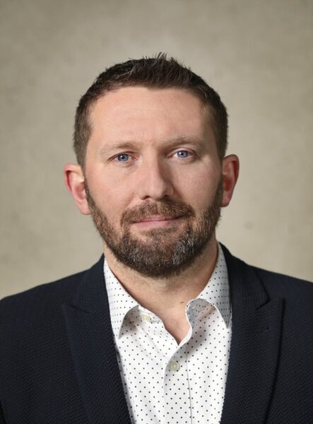 Shawn VanDiver studio headshot, navy blazer