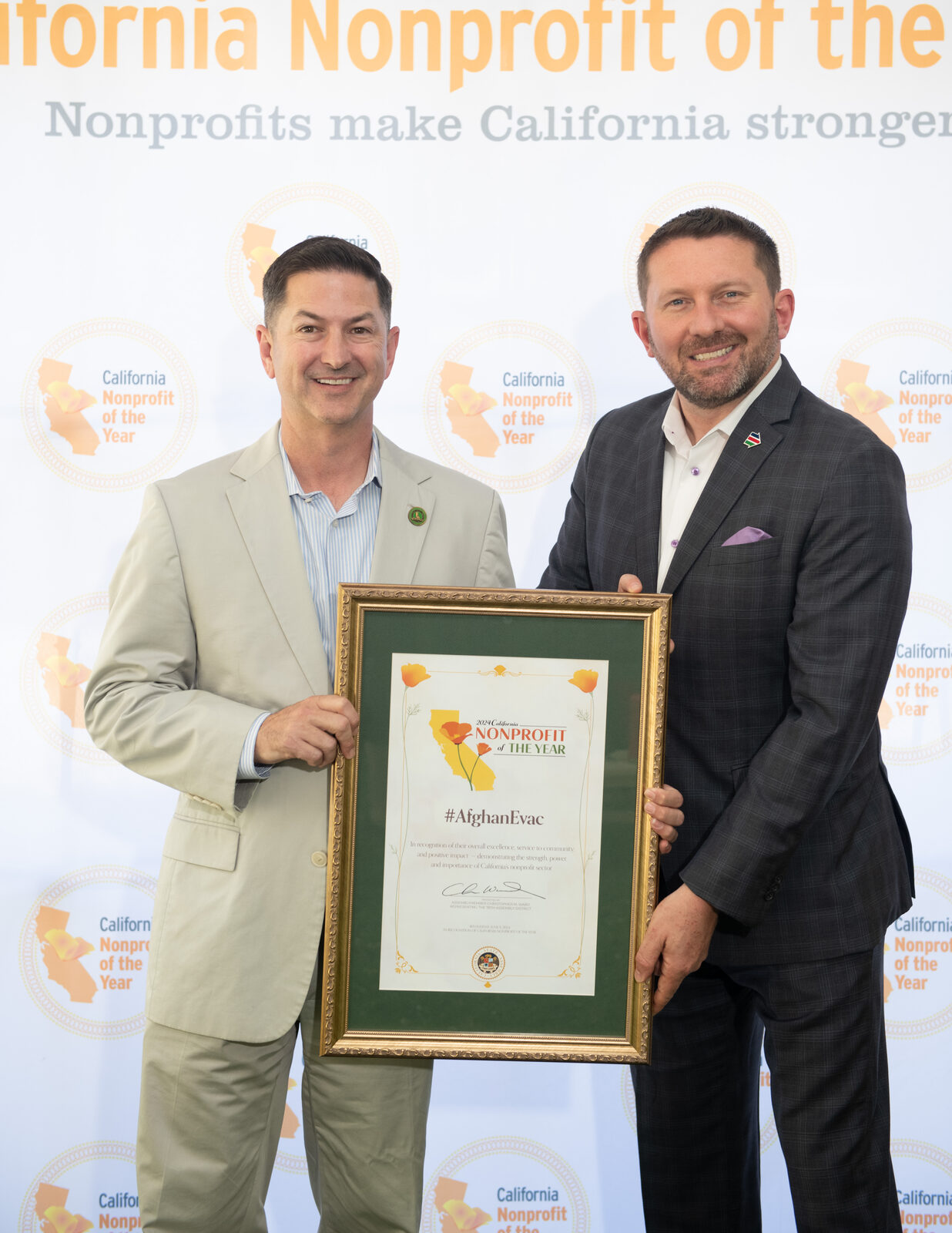 Shawn VanDiver accepting the California Nonprofit of the Year award for #AfghanEvac from Assemblymember Chris Ward