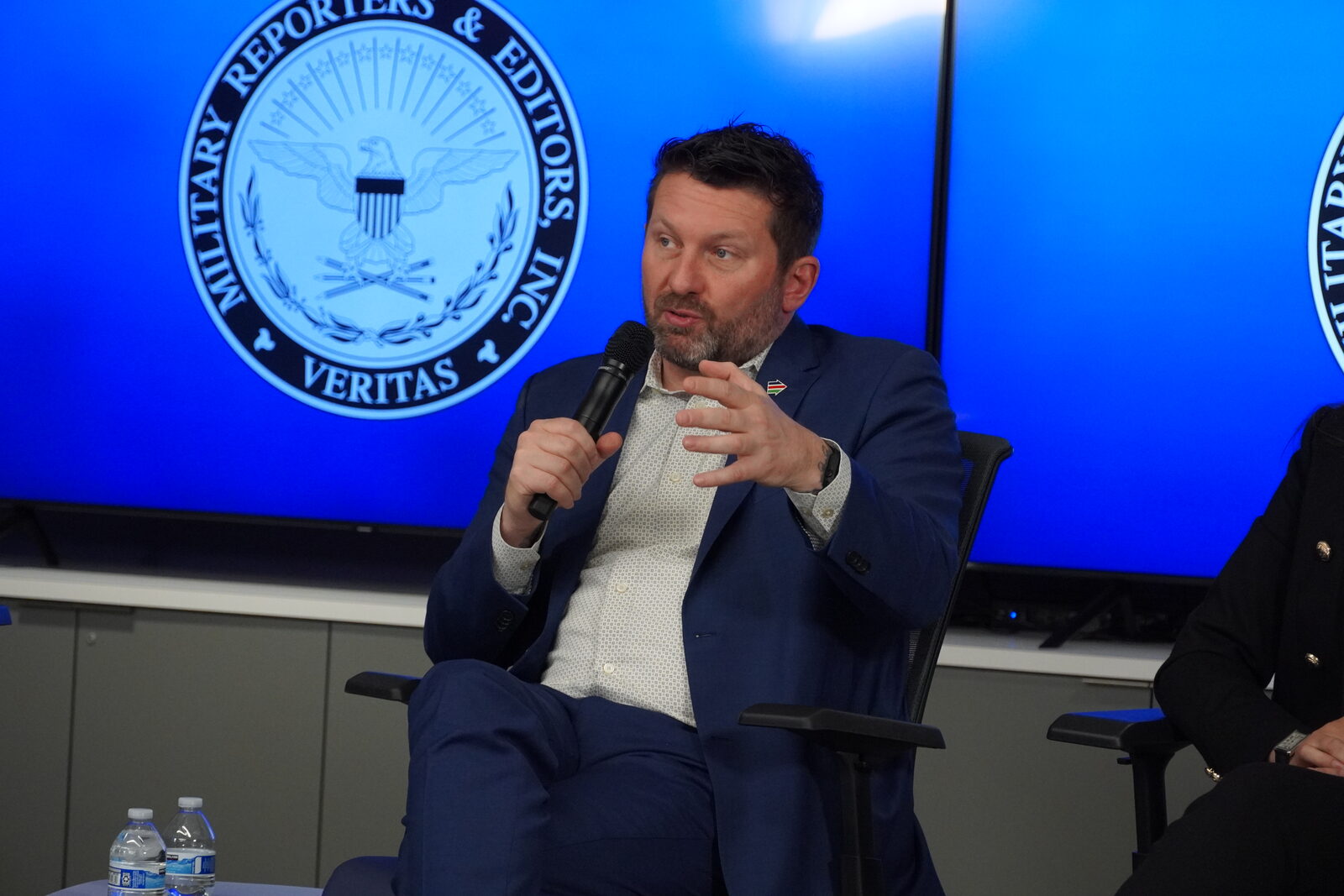 Shawn VanDiver speaking on a panel at the Military Reporters and Editors annual conference
